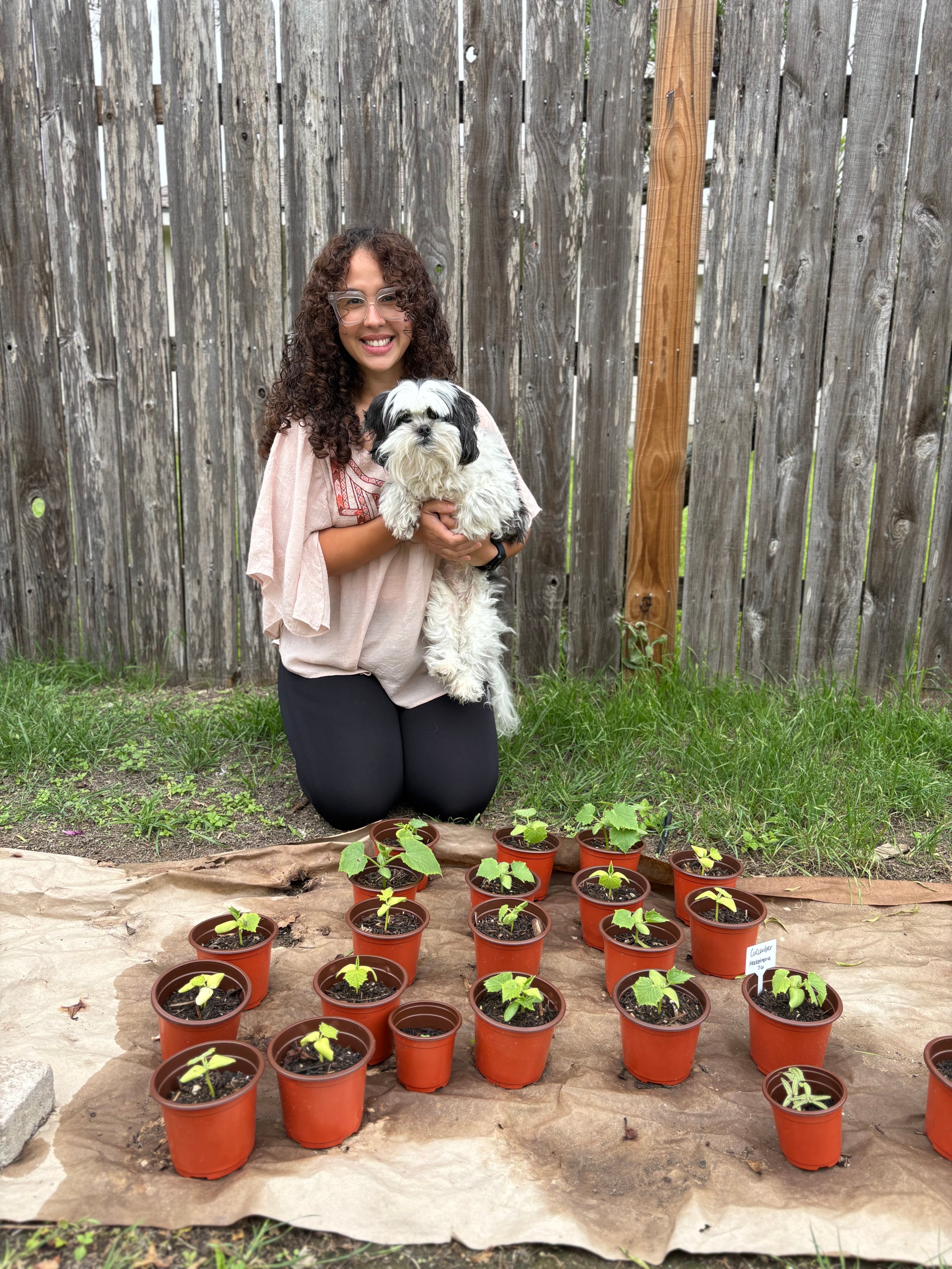 Karen Santana, LCSW - Founder of Forestalled with her senior dog Cuddles and baby cucumber seedlings